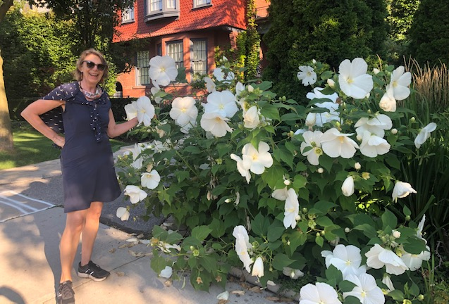 Photo of Mary Newberry, Freelance Editor and Indexer, standing next to a giant hibiscus.