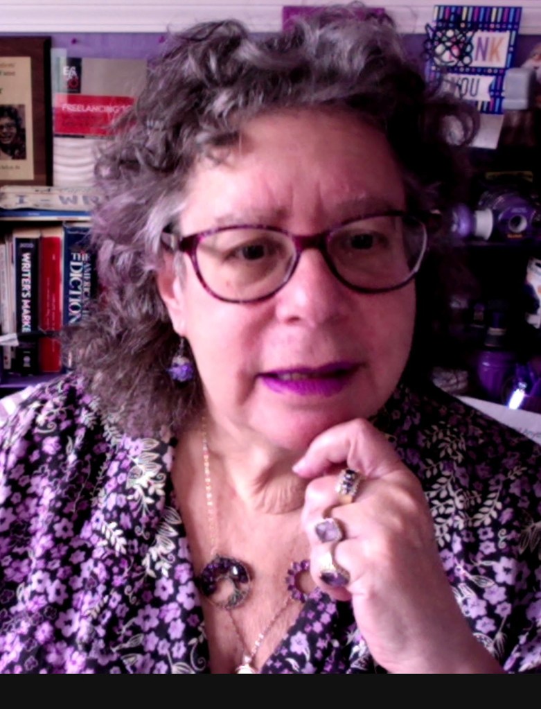 Photo of Ruth E. Thaler-Carter sitting at her desk.