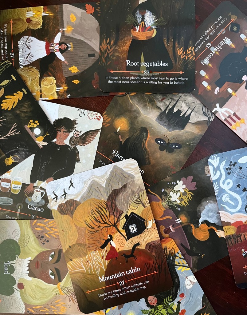 A series of oracle cards spread over a table.