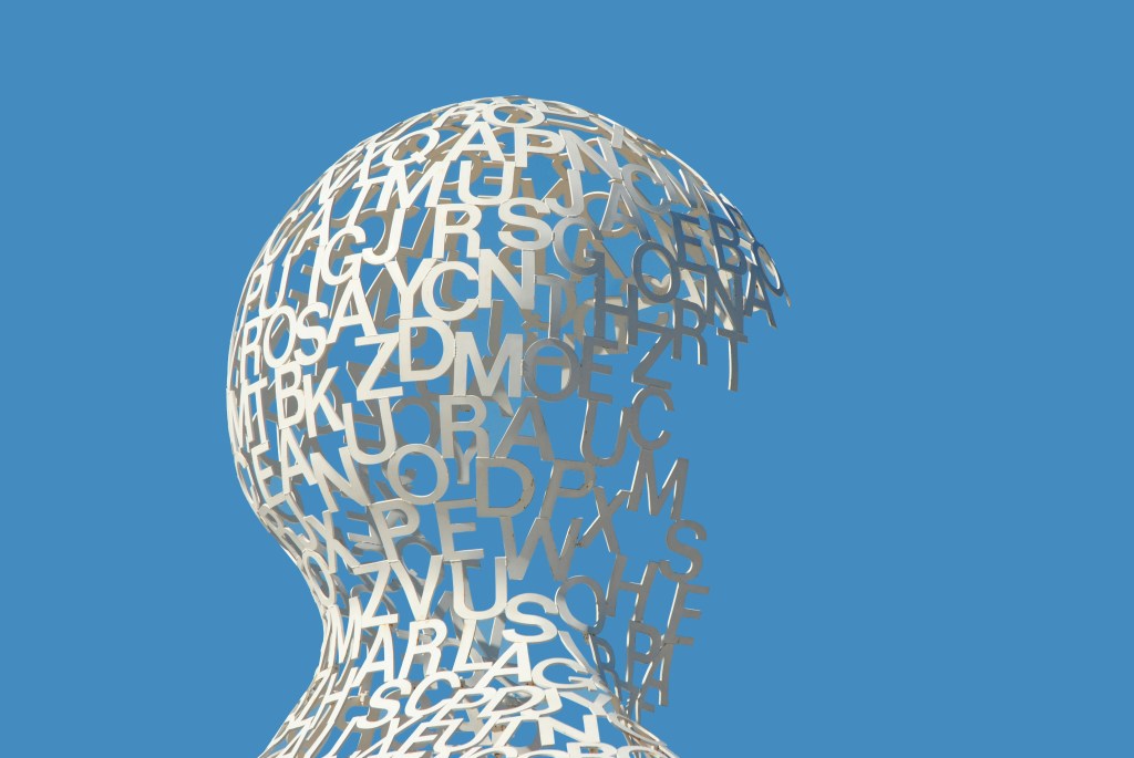 A sculpture of a head formed with letters.