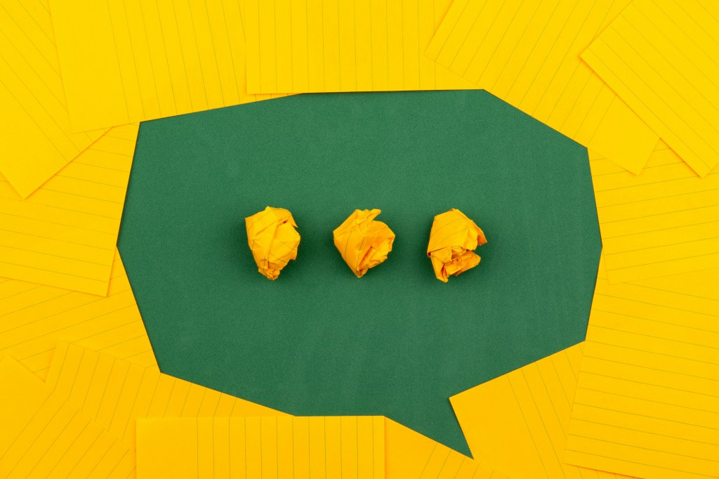 A speech bubble made from yellow paper paper and green cardboard.