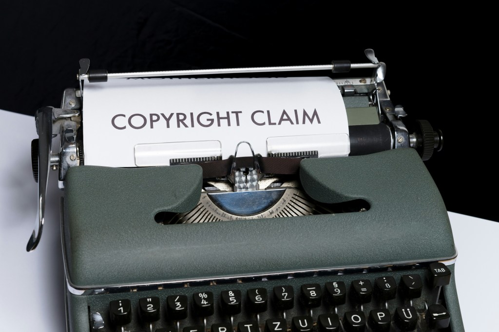 An old typewriter with a sheet of paper on which "Copyright Claim" is typed. 